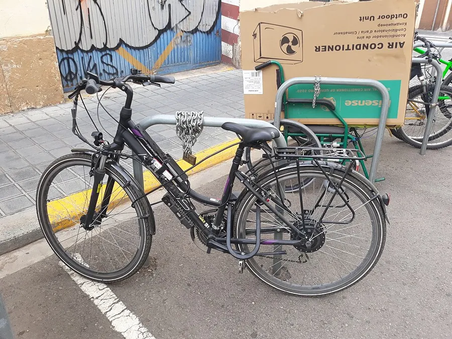 Electric bike locked with a chain and U-lock in the street