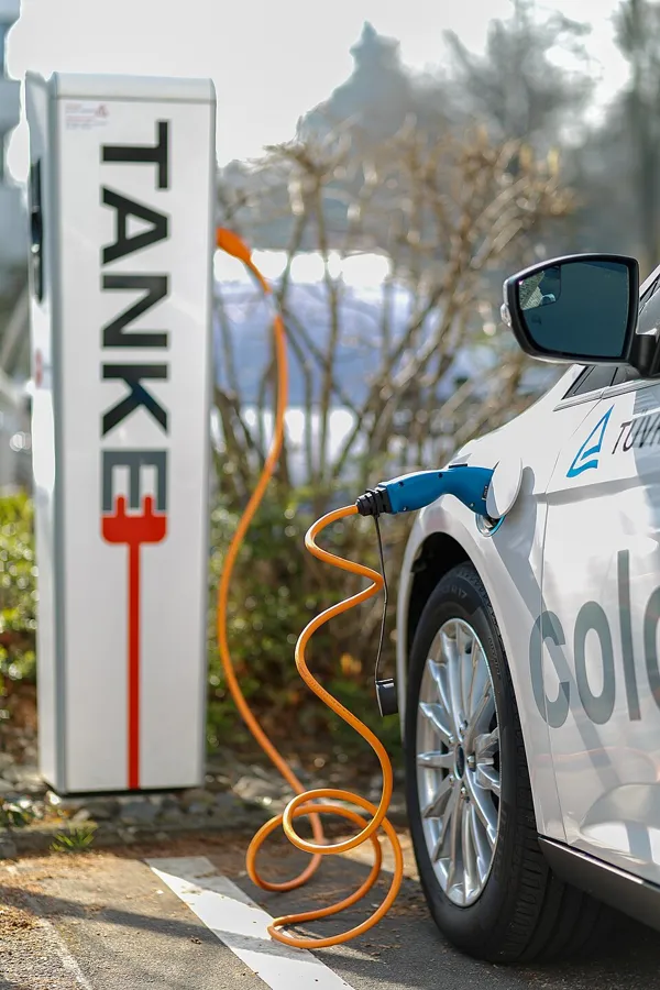 Electric car plugged into a public charging station