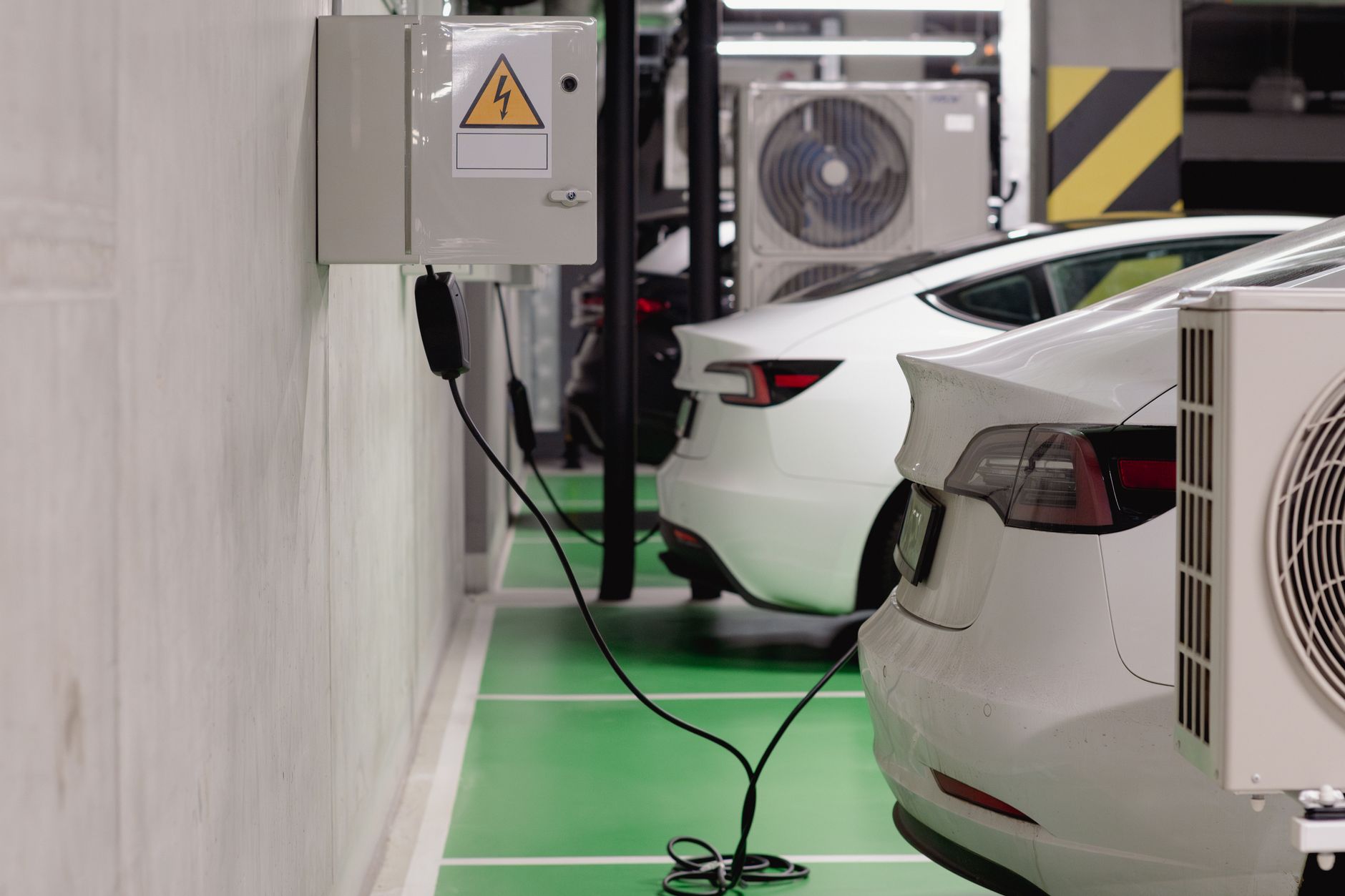 Electric cars charging in an underground car park, illustrating leasing