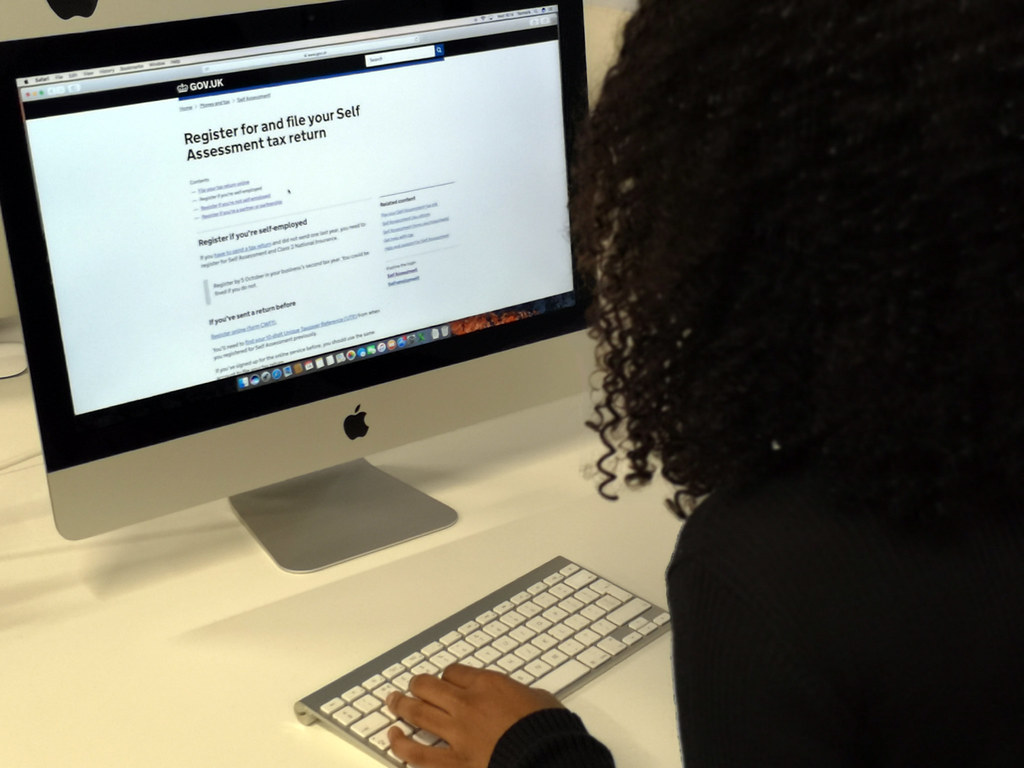 Person completing a vehicle registration procedure online without using ANTS