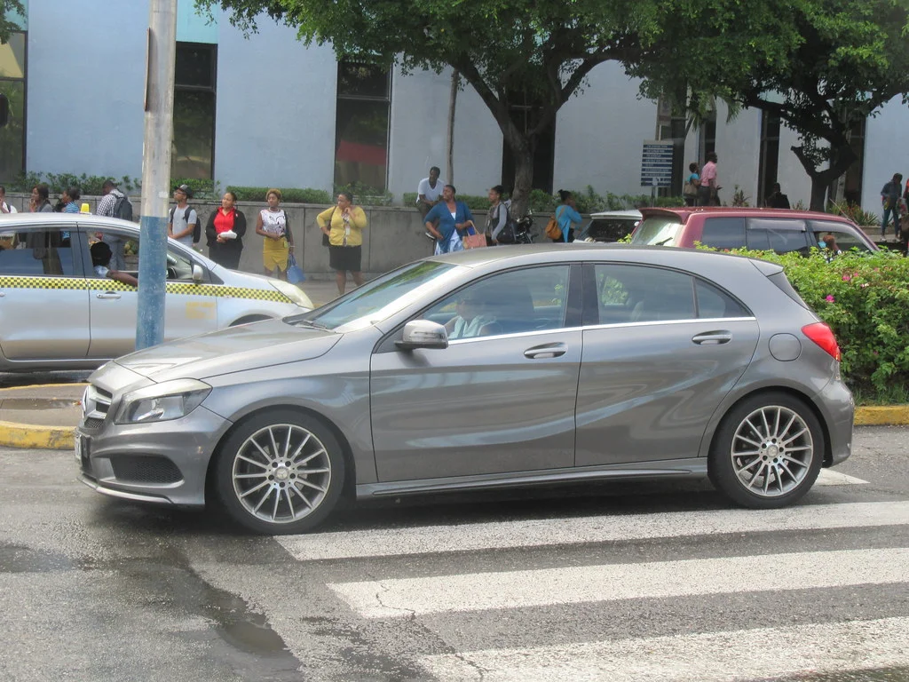 Grey Mercedes A-Class parked in a city street, three-quarter front view